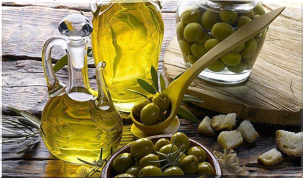 Bottle of olive oil and loose olives