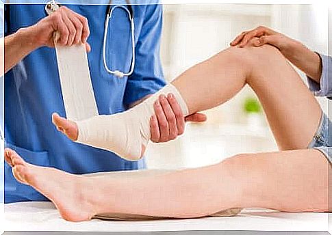 A doctor bandaging someone's ankle