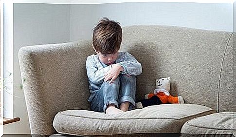 Withdrawn child sits on the couch