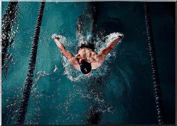 man swims butterfly stroke